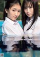 A couple of young women standing next to each other in a pool.