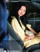 A woman sitting in the back seat of a car.